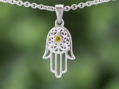 Die Hand der Hamsa mit gelbem Diamanten